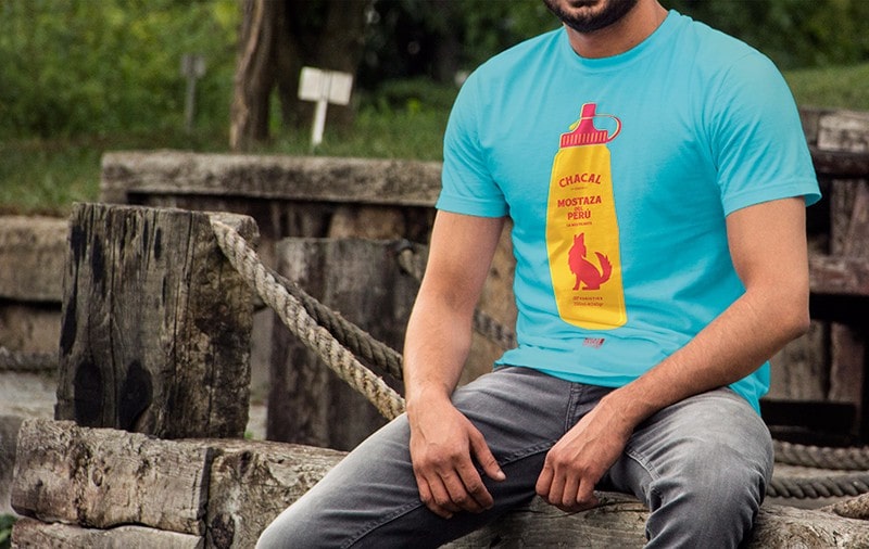 Photograph in short shot of a boy wearing a shirt with the Mostacero illustration.