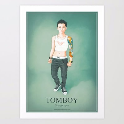 Photograph of a framed poster with the Tomboy design, a masculine girl drawn on a green background. In the lower part, the word Tomboy is read in large.